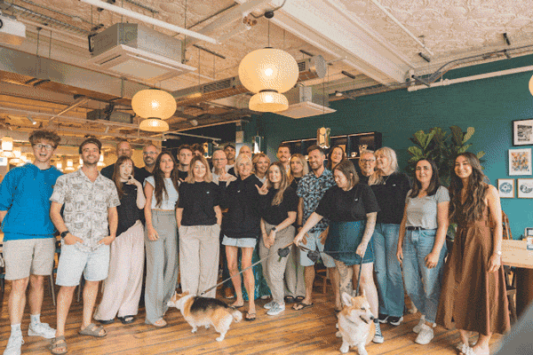 The whole agency team waving for a group photo