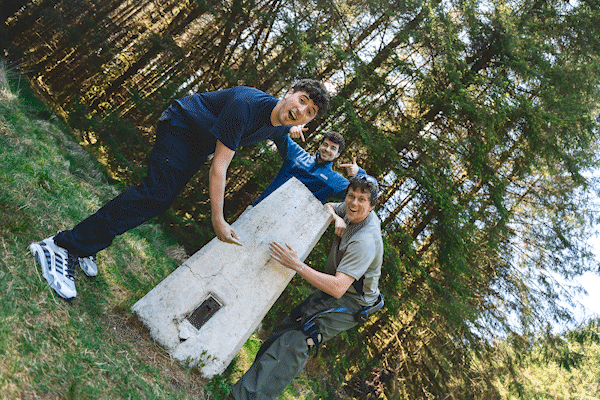 The lads laughing at the trig point
