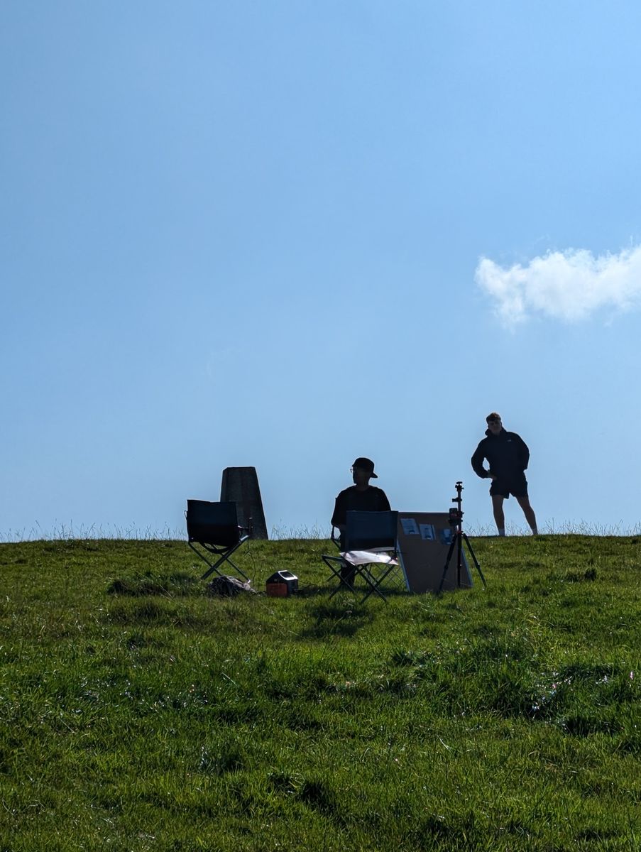 A trig pillar standing in the landscape on location